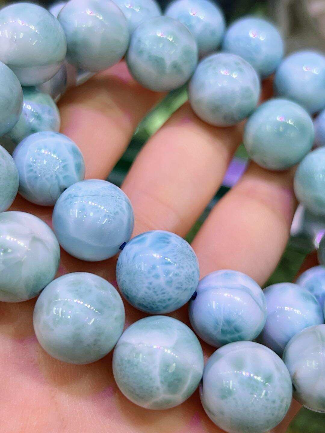 High-quality natural Larimar beads with ocean wave patterns, available in 6mm, 8mm, 10mm and 12mm sizes